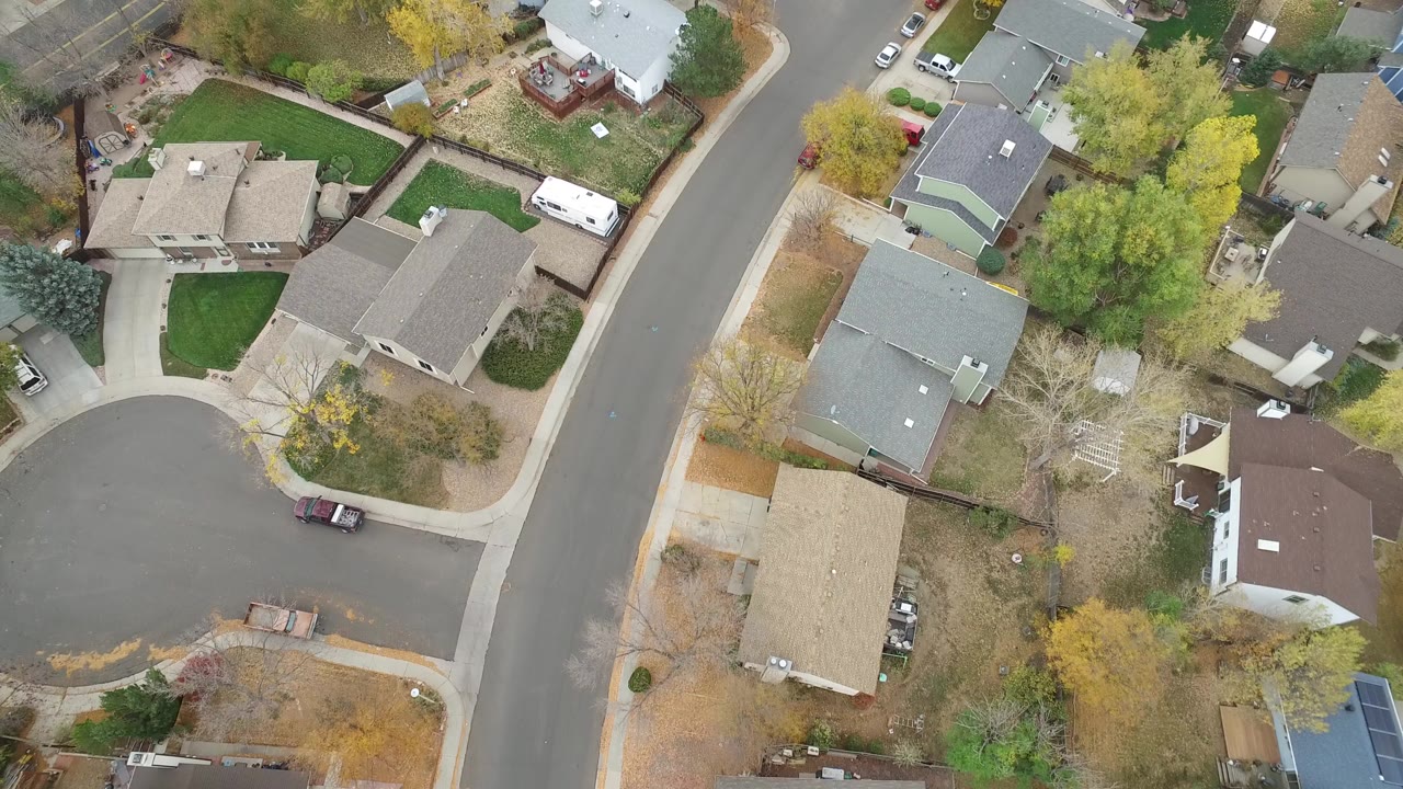 Aerial view of houses around a curved residential street.