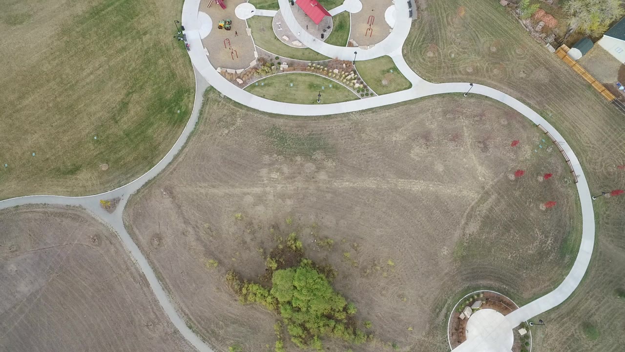 Overhead view of curving paths through open grassland