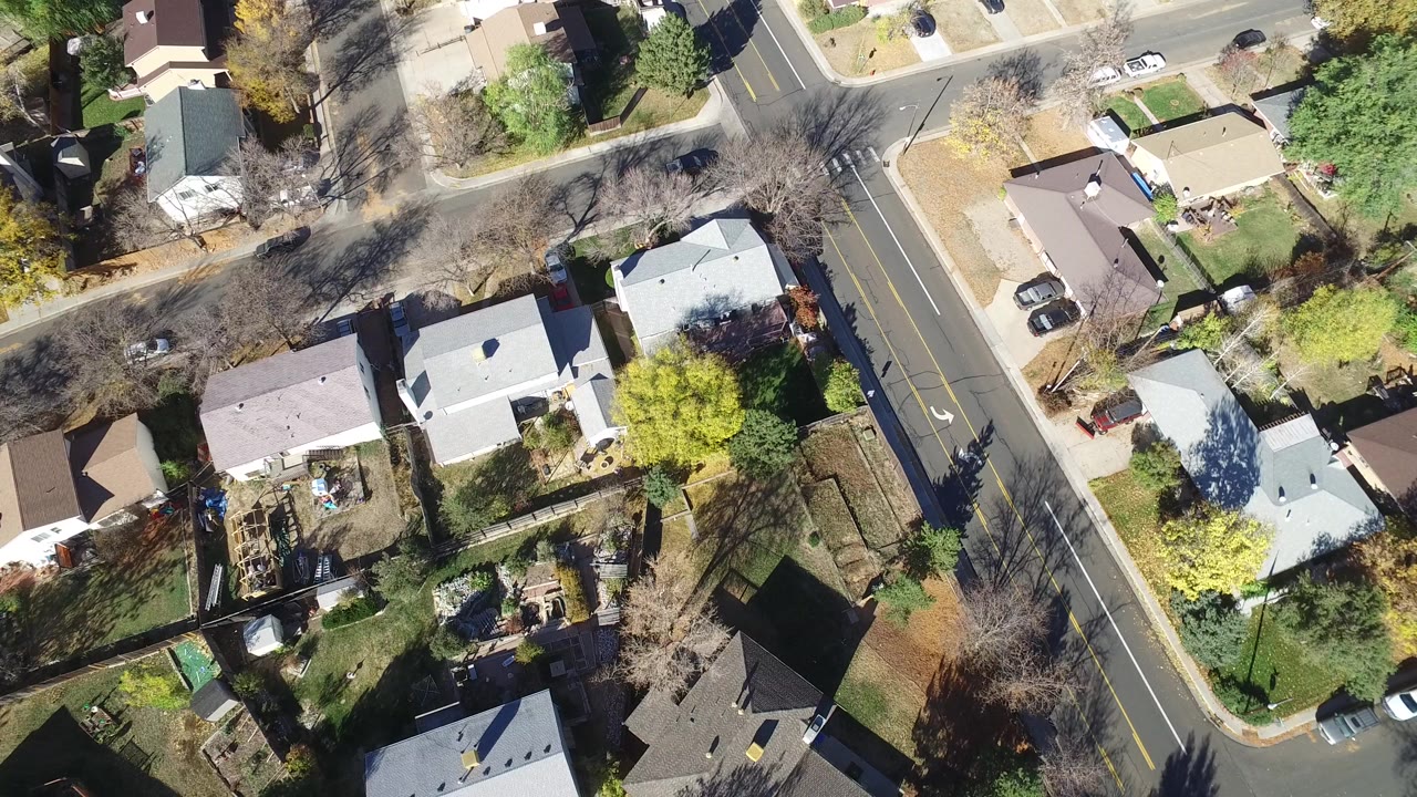 Overhead aerial view of Hidden Lake, Colorado homes, driveways, trees, and two intersecting residential roads at 0:00, with no visible people.