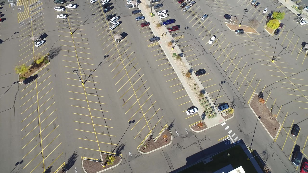 Drone view of parking lot lanes and building corner