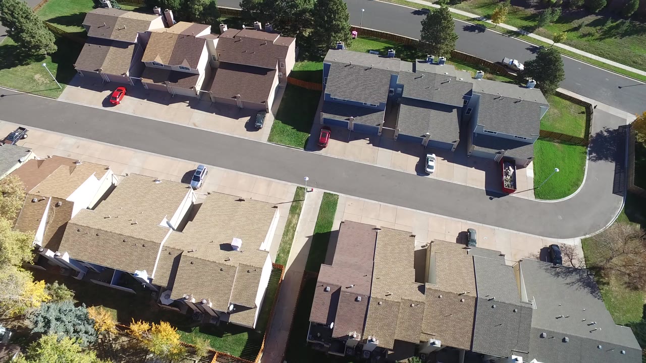 Overhead view of houses along a curved residential road.
