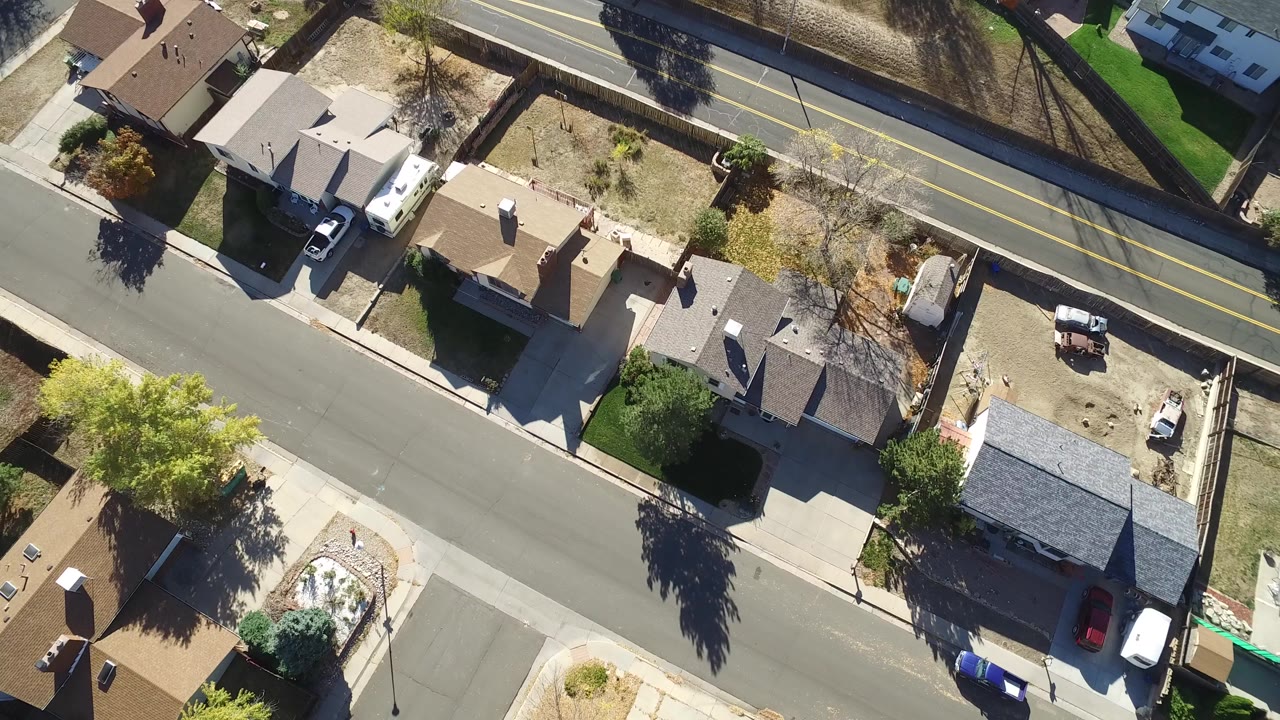 Overhead view of houses along an empty residential street.