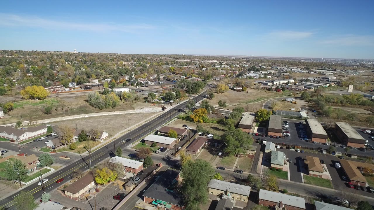 Aerial view of a diagonal road through houses and trees