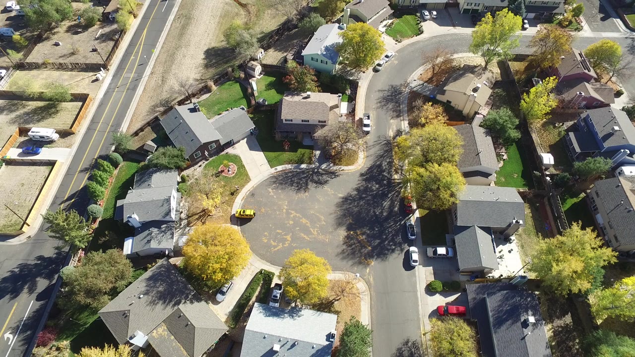 Overhead view of suburban homes around a curved cul-de-sac.