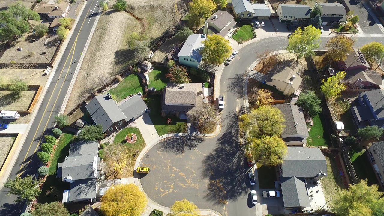 Overhead view of a residential cul-de-sac and nearby road.