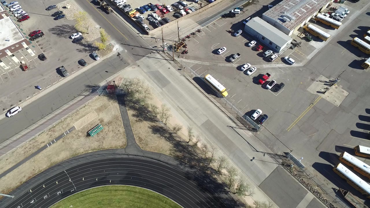High overhead view of parking spaces, buses, and nearby roads
