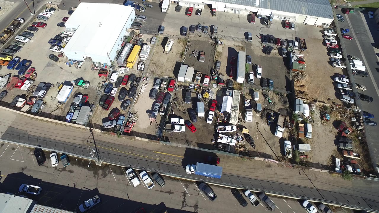 Top-down view of a storage yard and adjacent street.