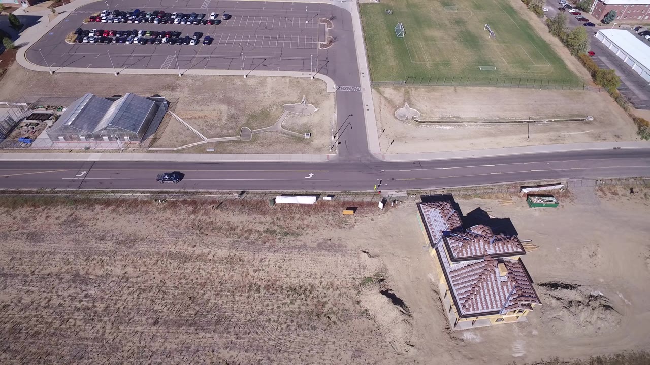 Overhead road beside parking lot and dry open land