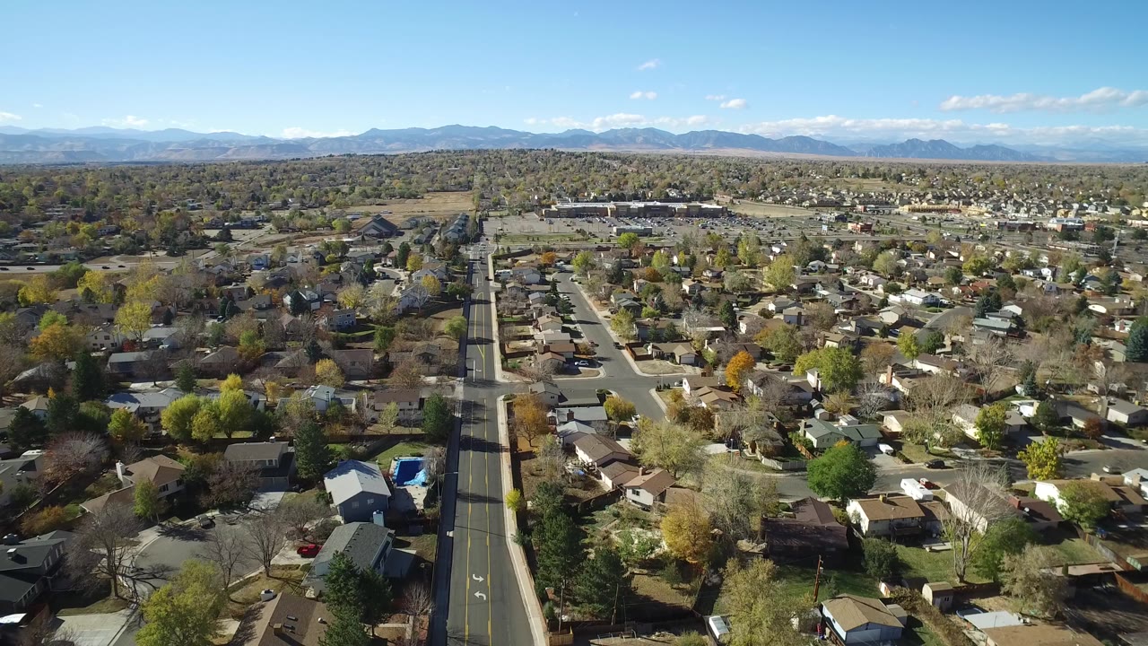 Aerial view over a suburban neighborhood and straight road