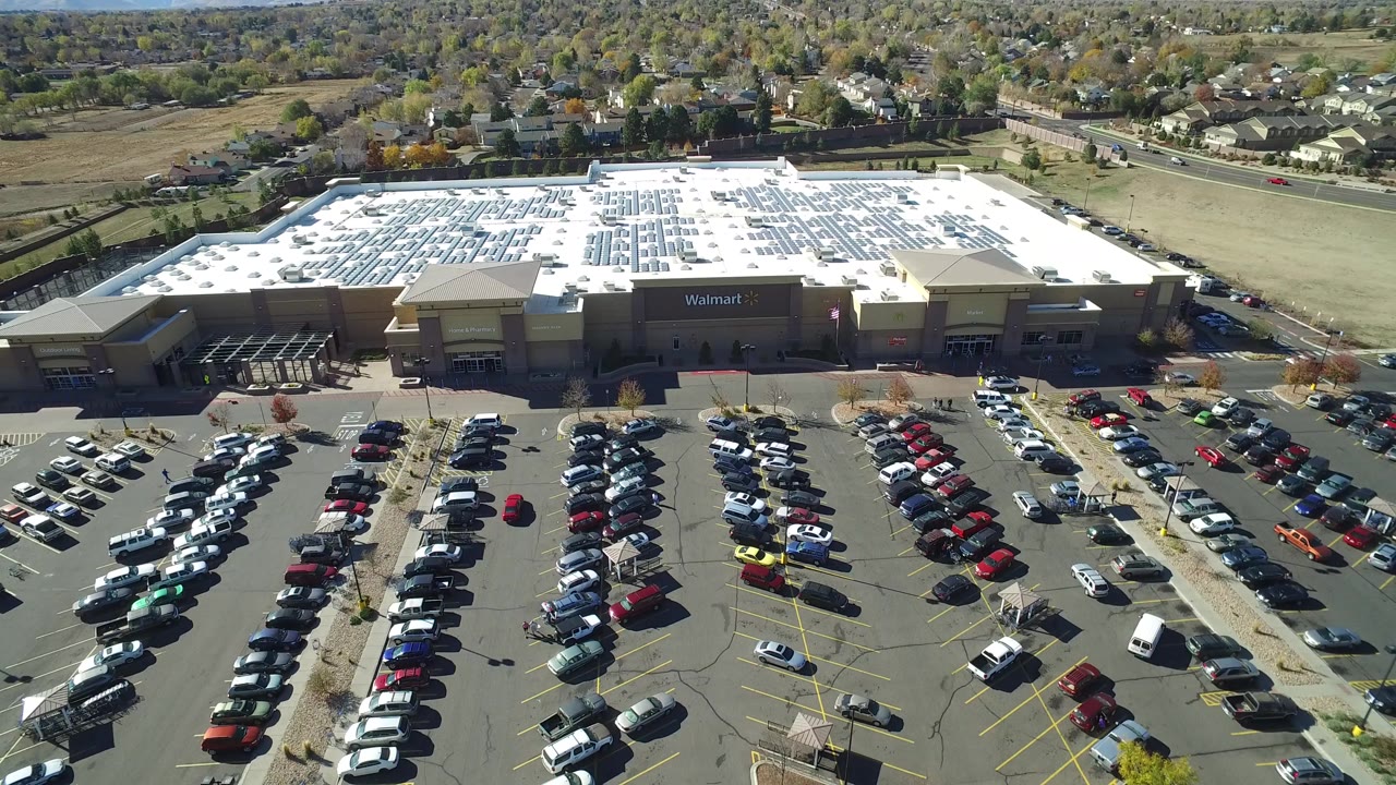 Aerial view of a Walmart parking lot with rows of cars