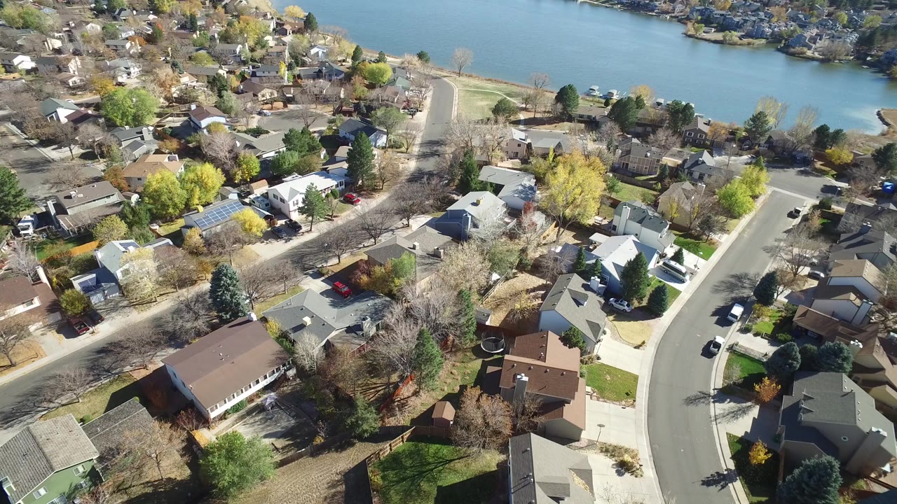 High aerial view of suburban homes beside a lake