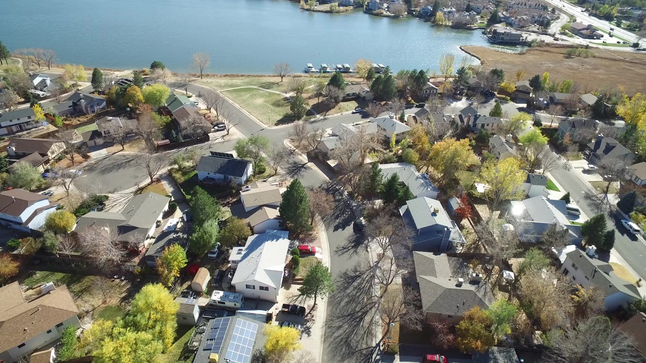 Aerial view of residential roads and houses beside a lake