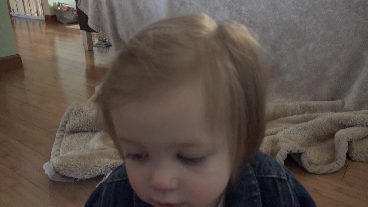 Toddler close to a low camera in a living room.