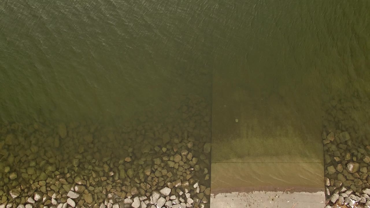 Overhead water surface with rocks along the lower shoreline