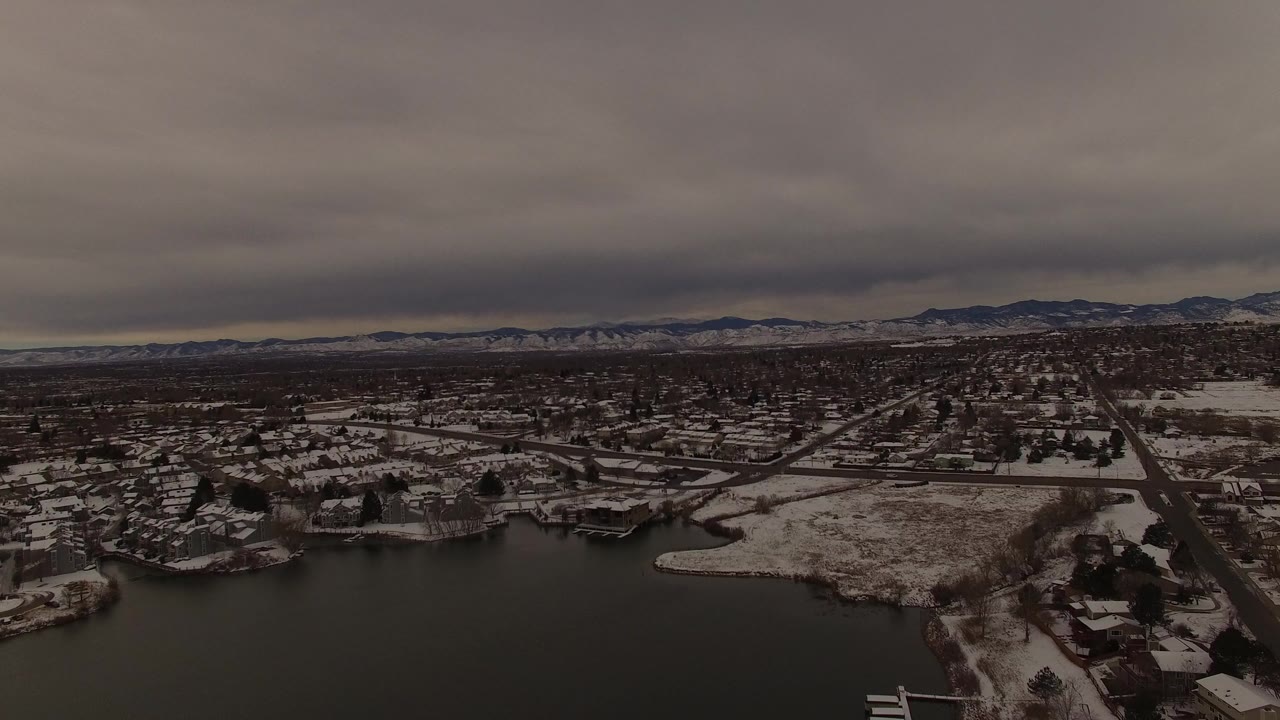 Overcast aerial view of a winter lakefront neighborhood.