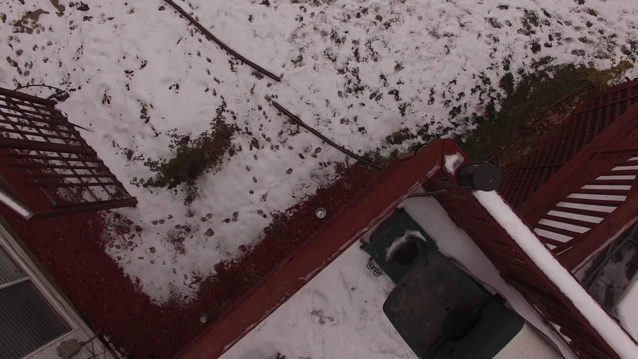 Deck corner and snowy ground below