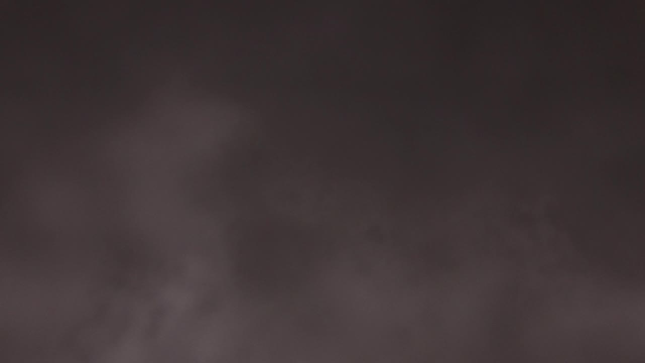 Soft brown-gray clouds fill the night sky in Jefferson, Colorado, with a darker band across the lower part of the frame and no visible people.
