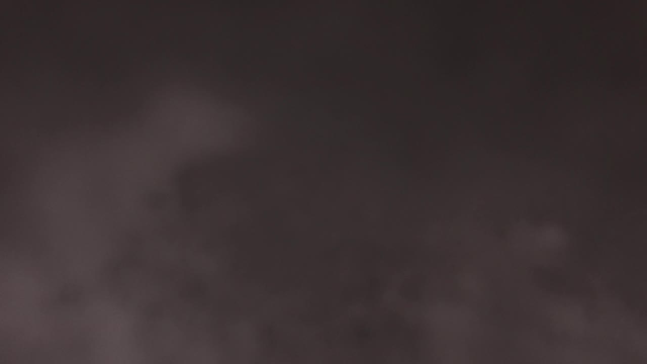 Blurred gray clouds against a dark brown sky