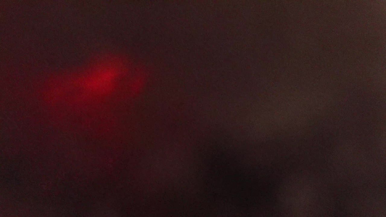 Dim cloudlike blur with a faint light mark