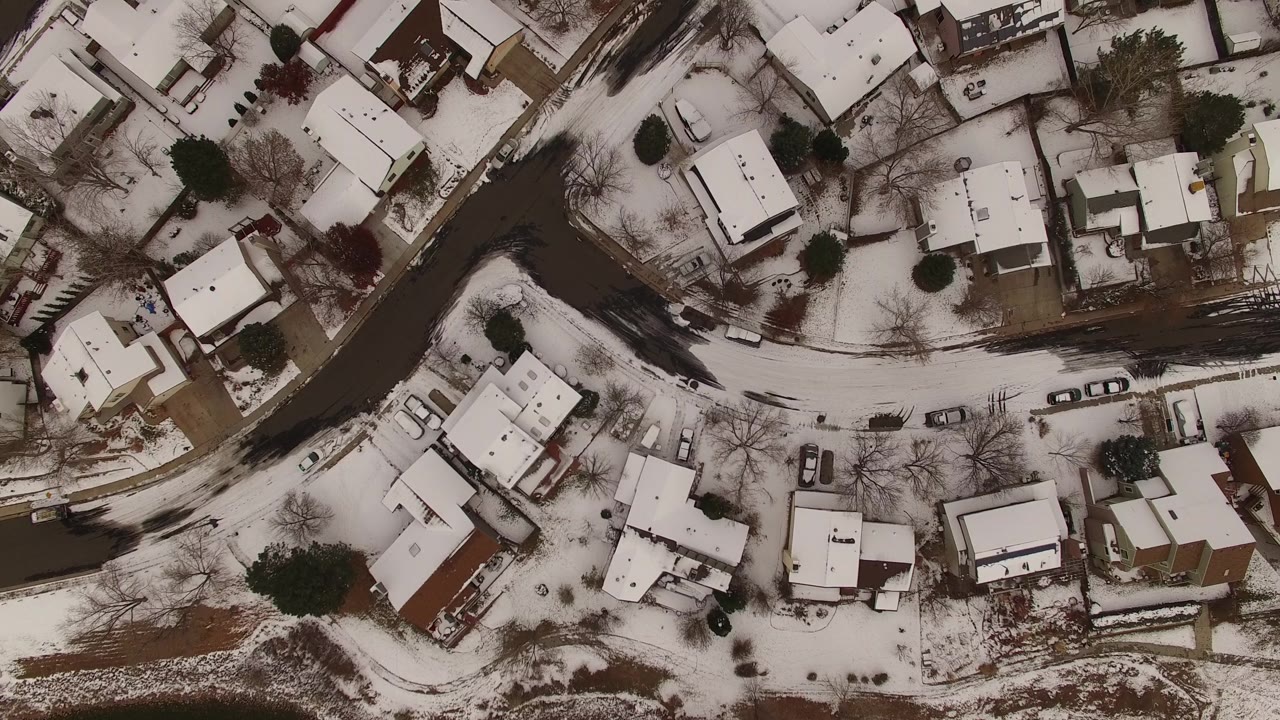 Top-down winter neighborhood with parked cars