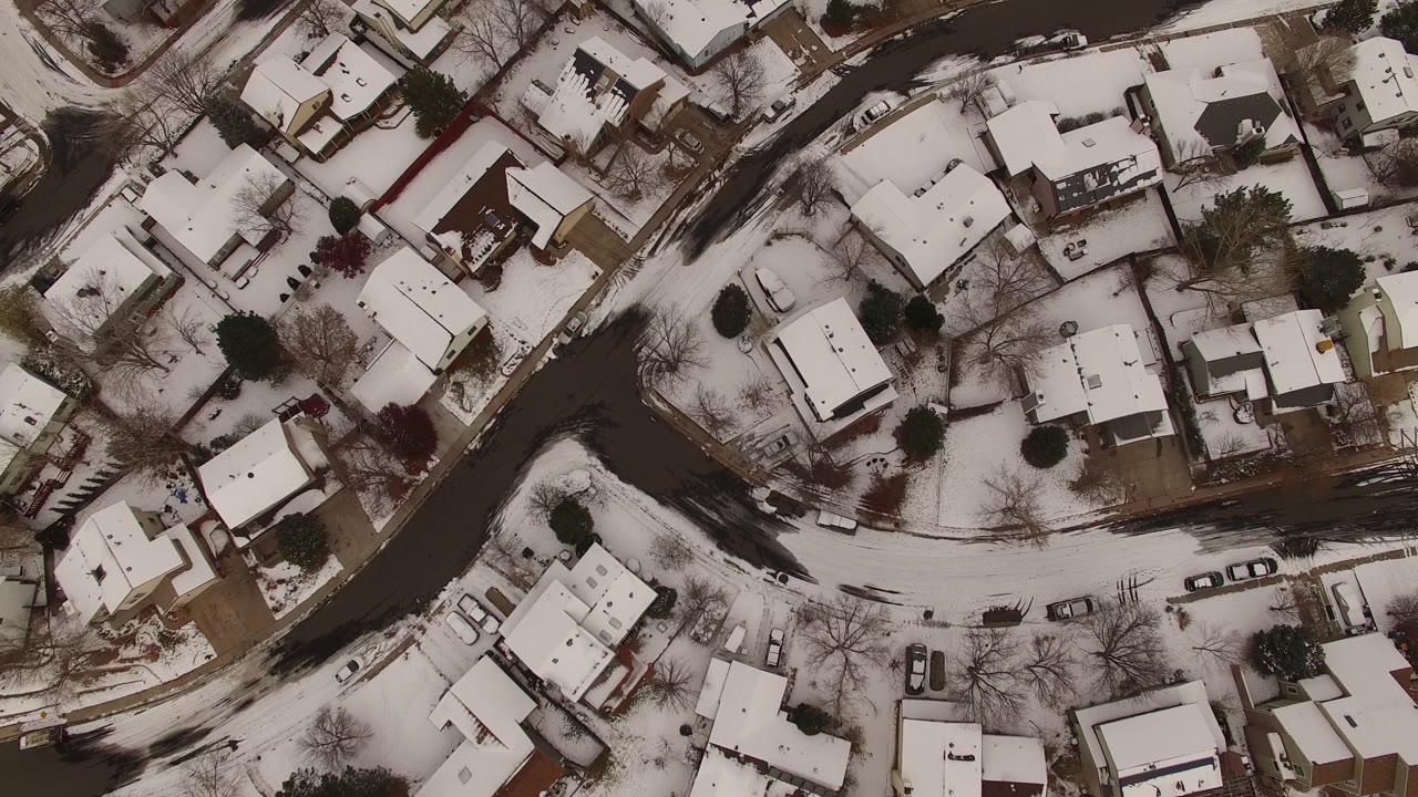 Top-down winter suburb with houses and roads