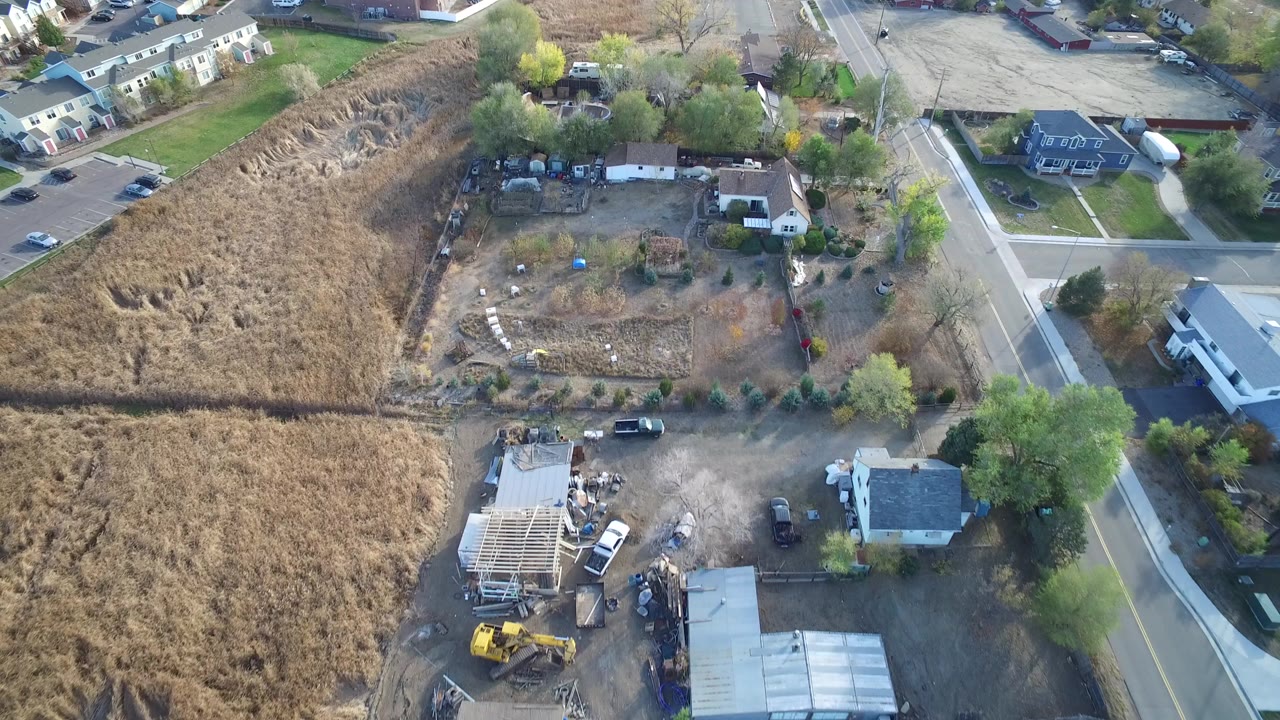 Oblique aerial view of homes beside dry fields and roads.