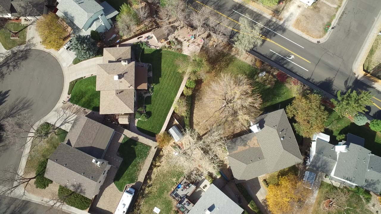Overhead view of suburban houses and a curved residential street.
