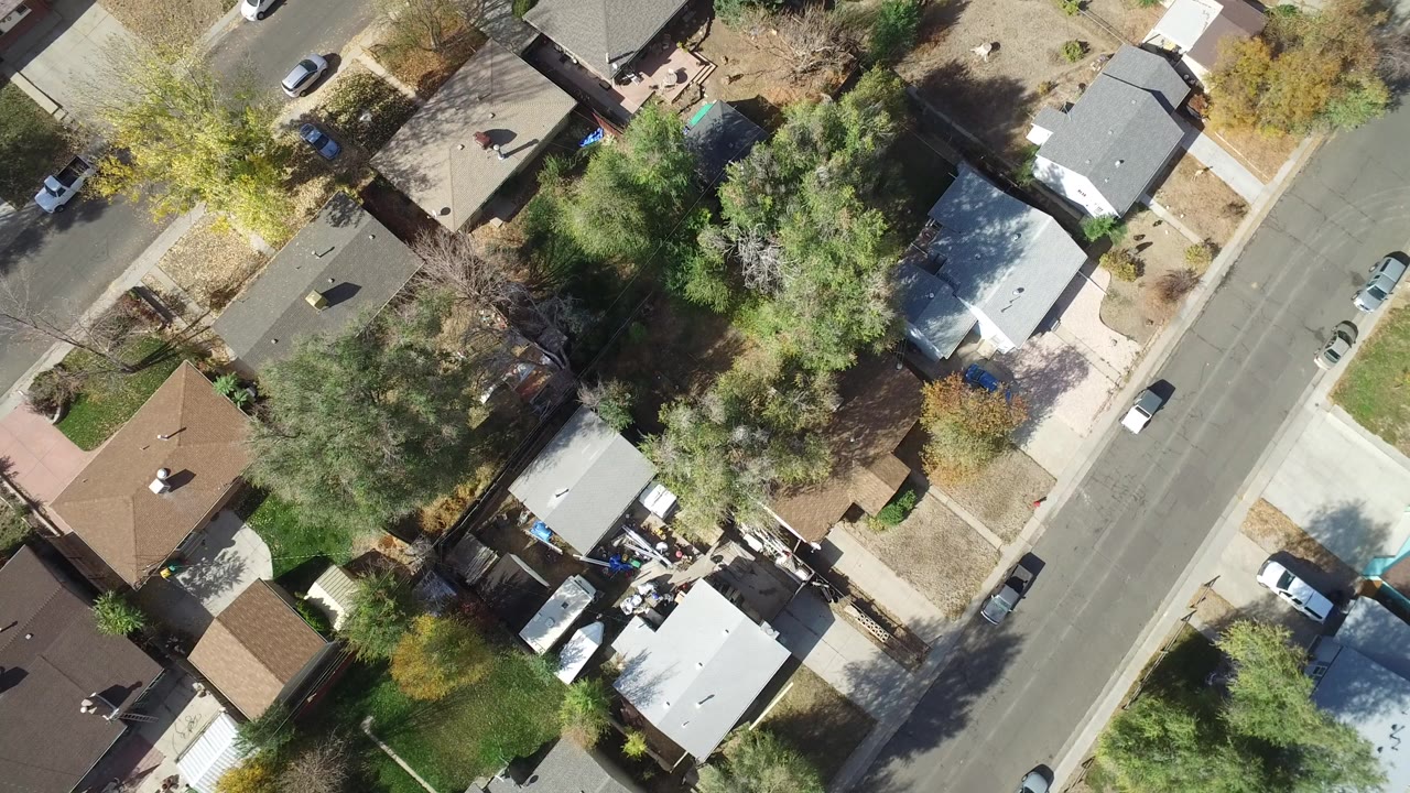 Overhead view of houses, trees, and a residential street.