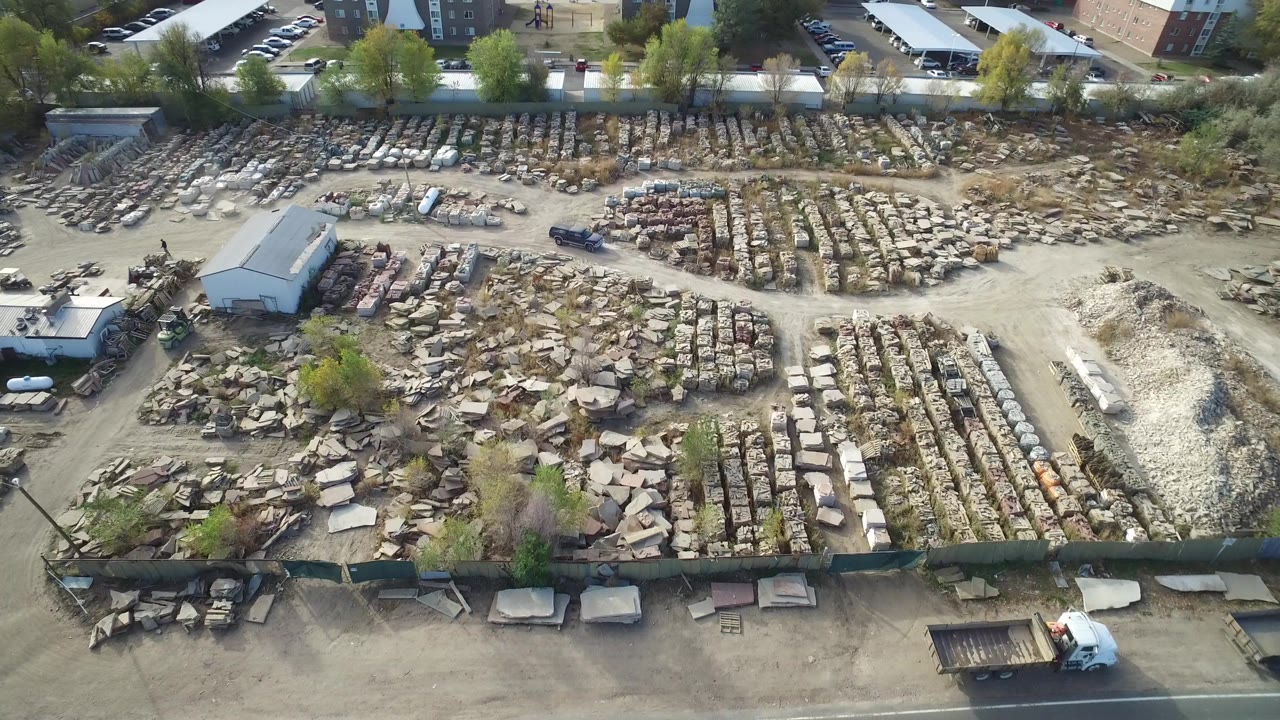 Aerial view of a rock supply yard beside a road.