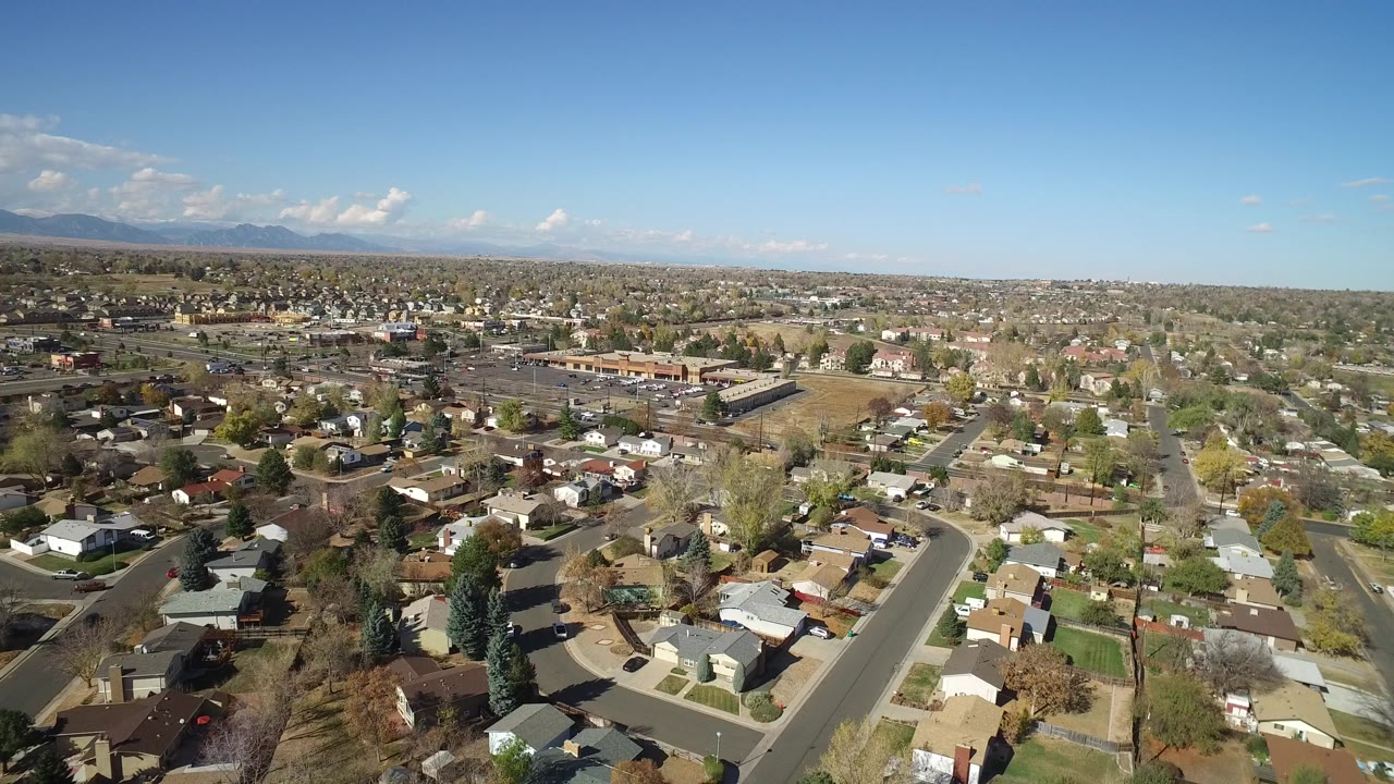 Aerial view of a suburban neighborhood under a clear blue sky.