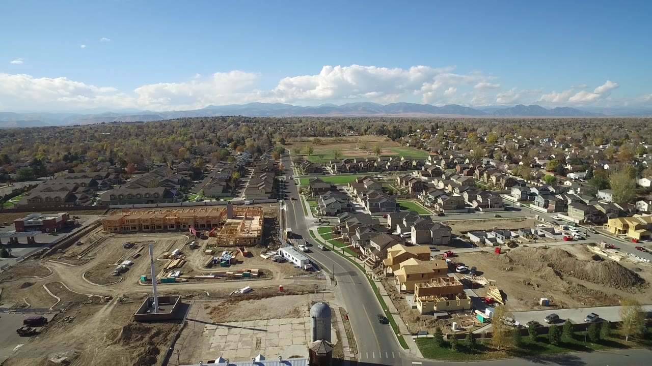 Residential subdivision and construction area seen from above under a clear sky.
