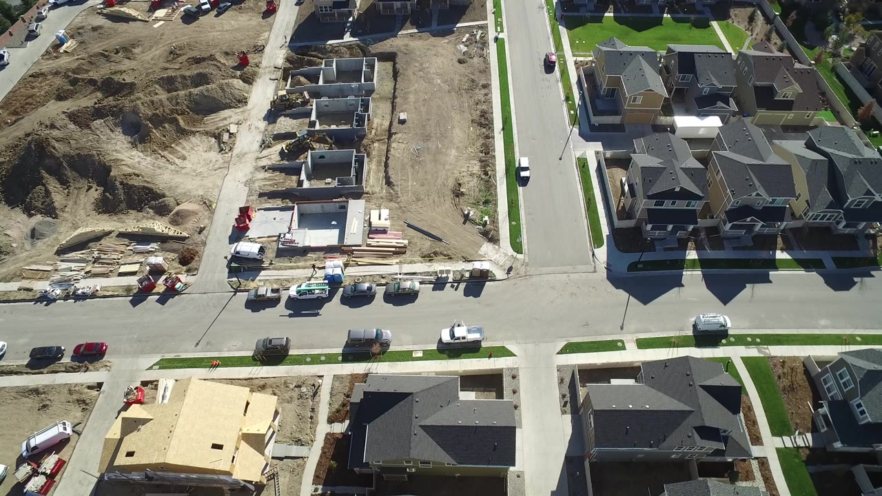 Aerial view of a residential intersection beside new home construction lots.