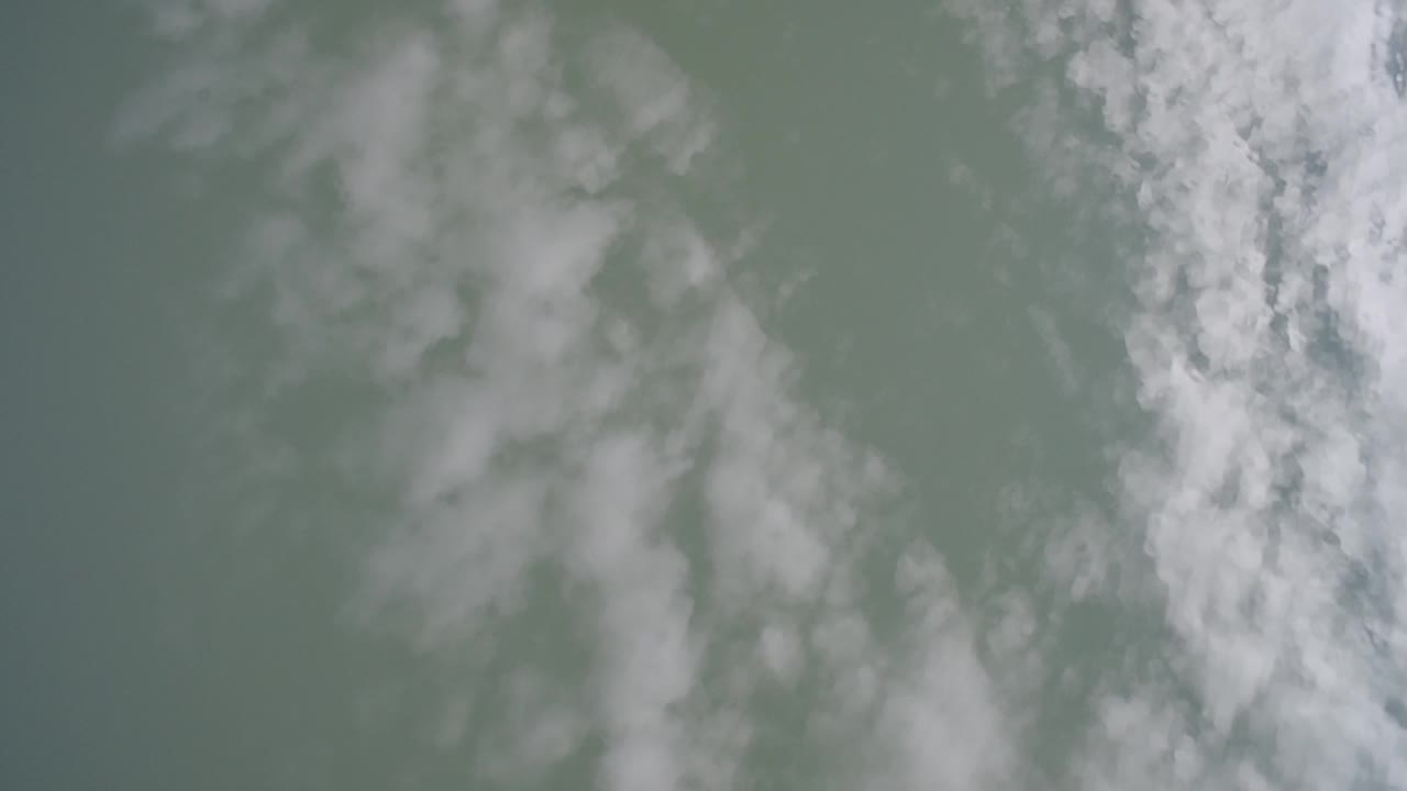 Second frame shows diffuse pale cloud shapes with a brighter vertical cloud band along the right side of the Hidden Lake Colorado aerial view, with no visible people.