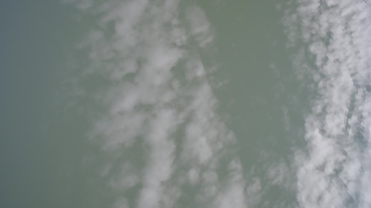 Green-tinted Hidden Lake, Colorado sky with a brighter broken cloud strip near the right edge and no visible people.