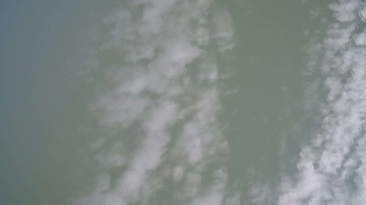 Wispy white clouds against a blue-gray sky.