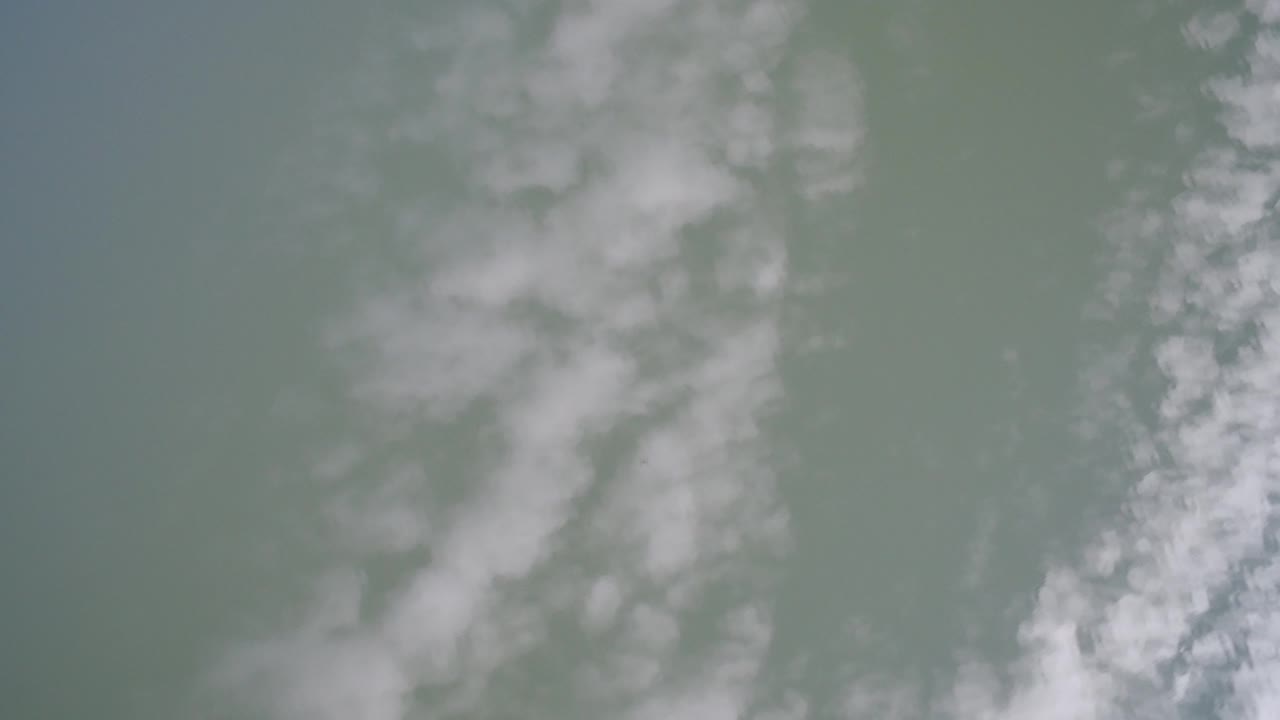 Soft green-gray surface with white mistlike streaks