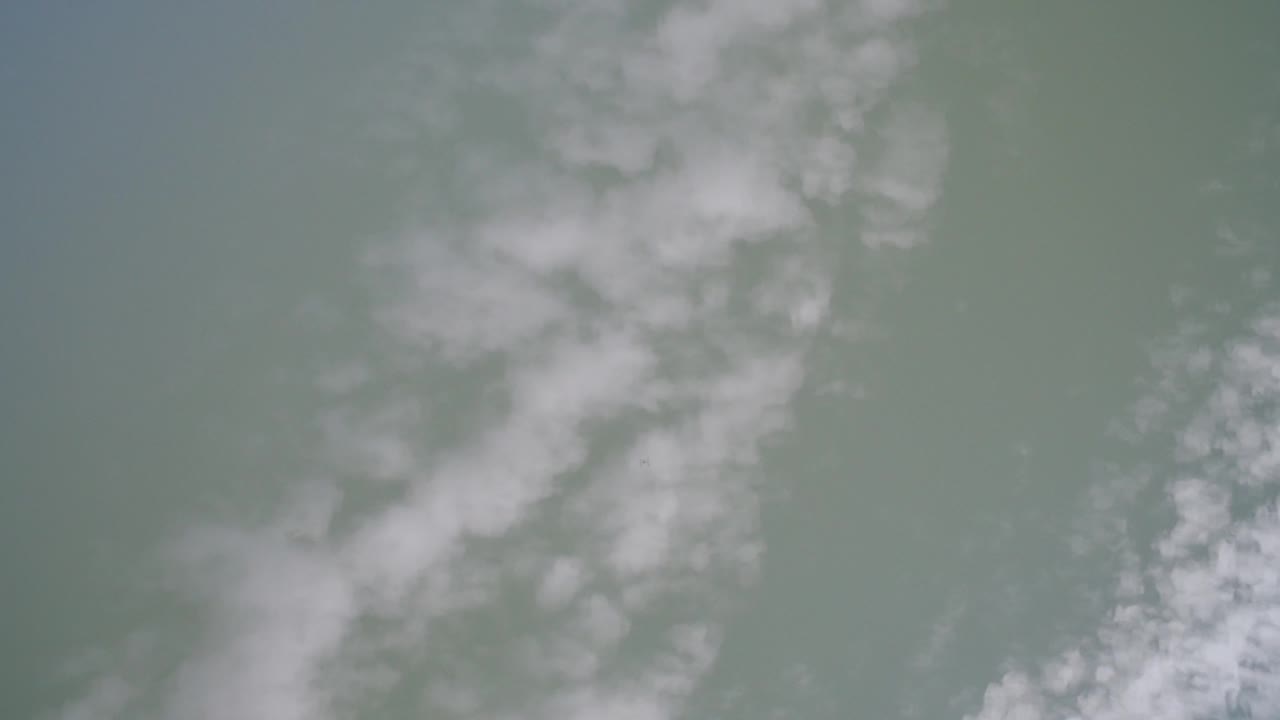 Pale green lake water with soft white surface patches