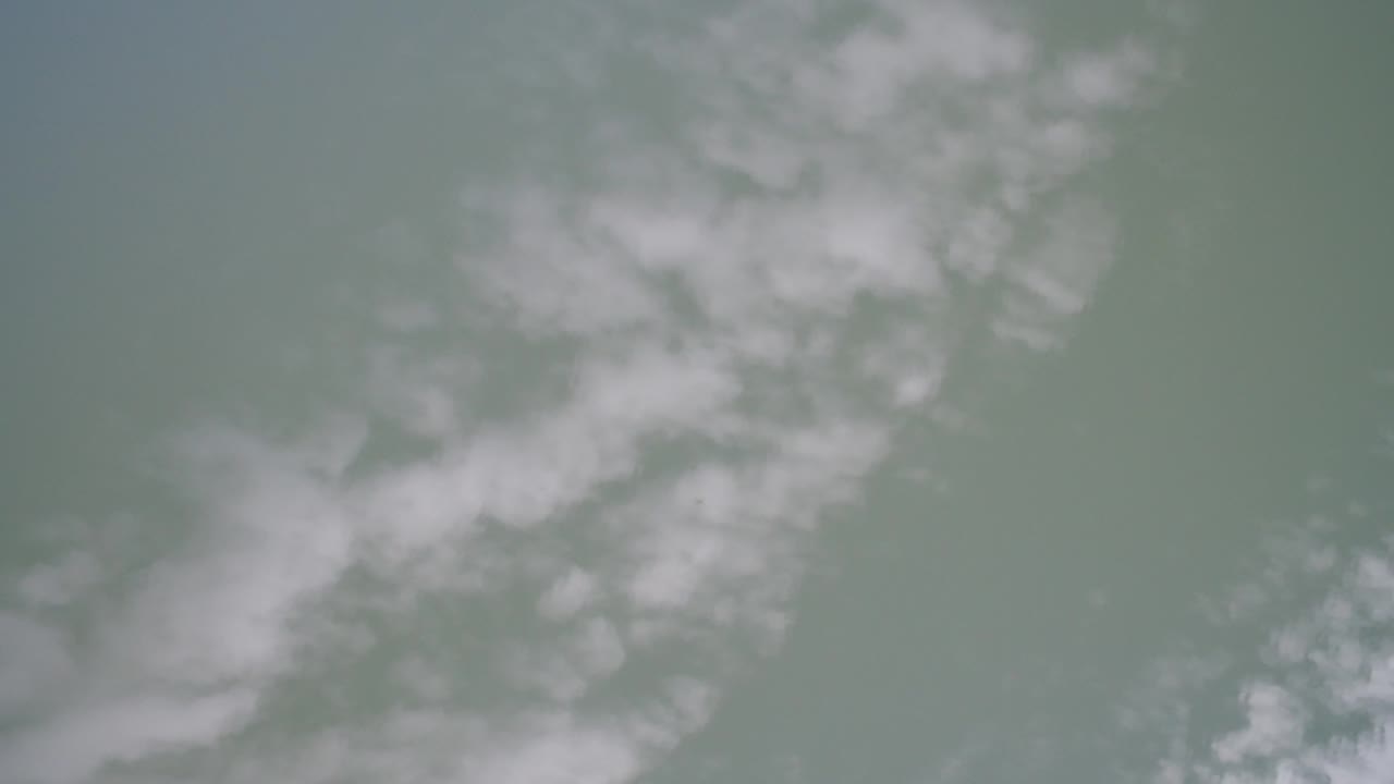 Soft cloud reflection over rippled lake surface.