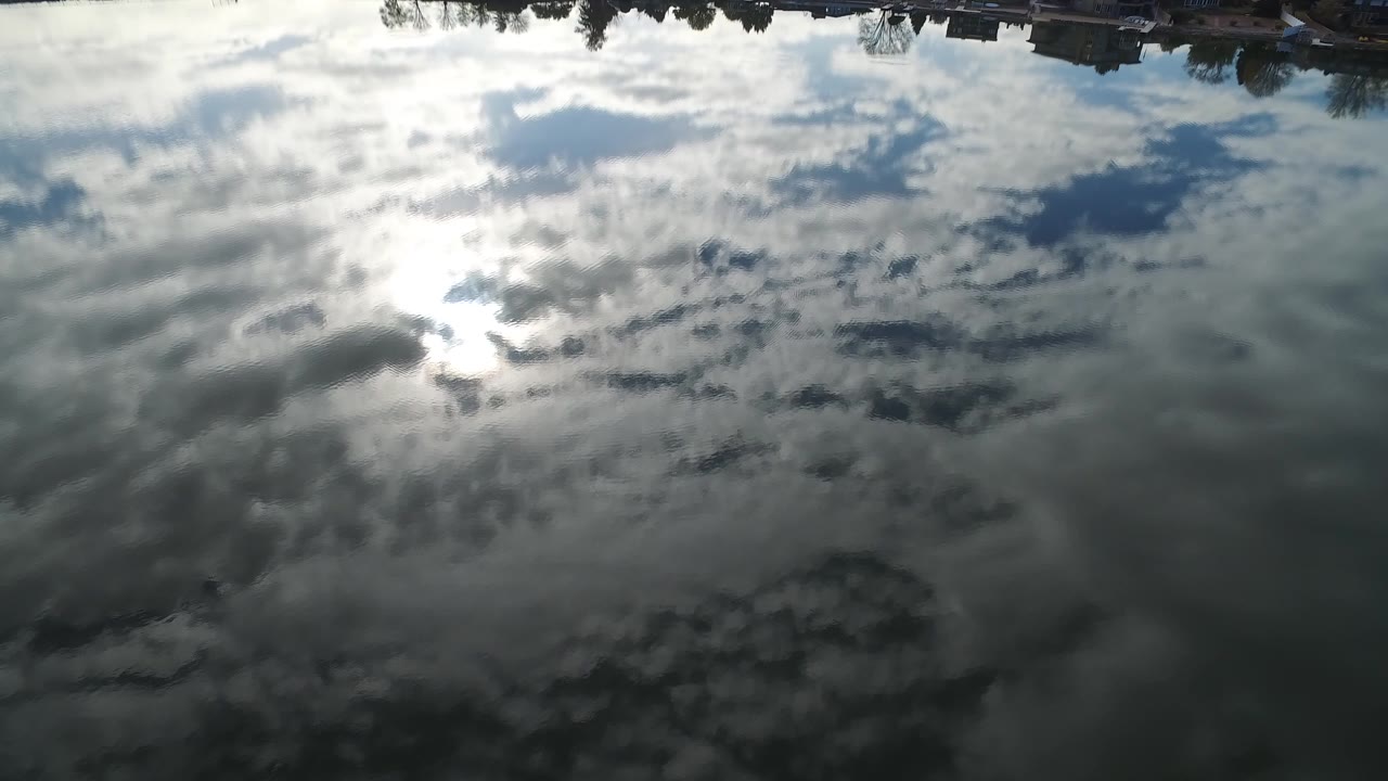 Large cloud reflection covering lake surface