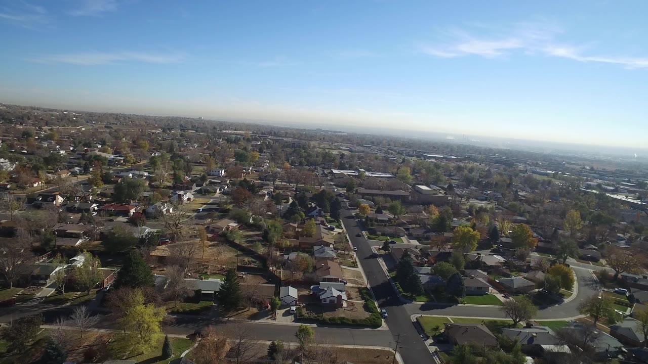 Aerial frame of Hidden Lake, Colorado showing a residential grid, mixed tree cover, low rooftops, and no visible people.