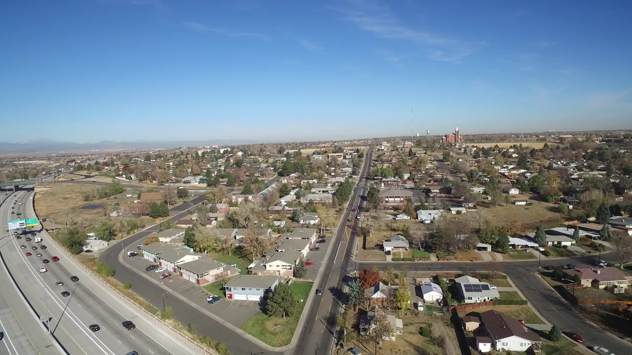 Aerial view of highway traffic beside a residential neighborhood
