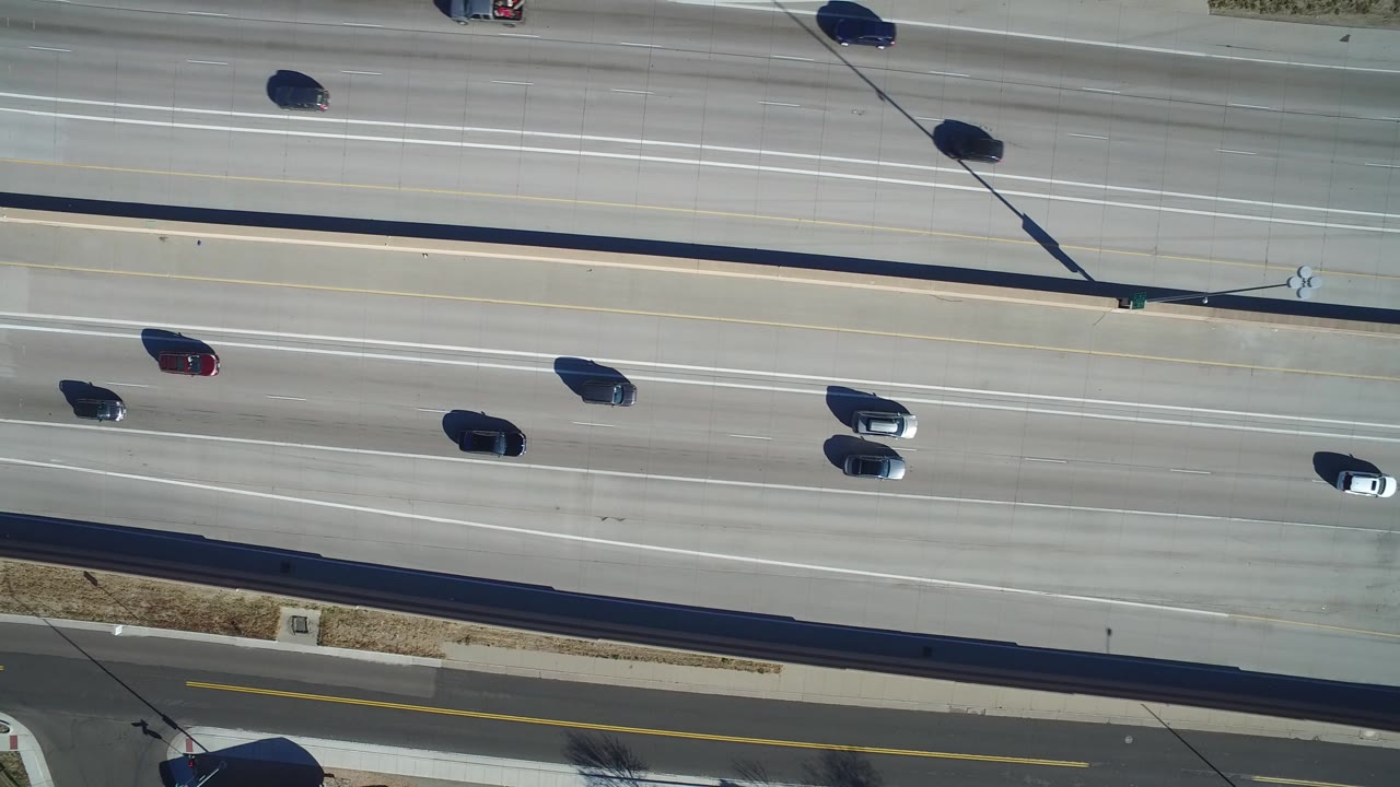 Overhead view of cars on a multi-lane highway.