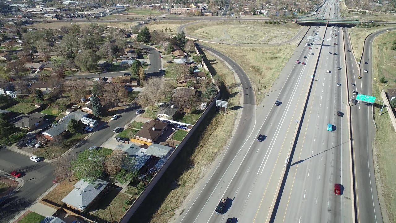Aerial view of a multi-lane roadway beside a residential neighborhood