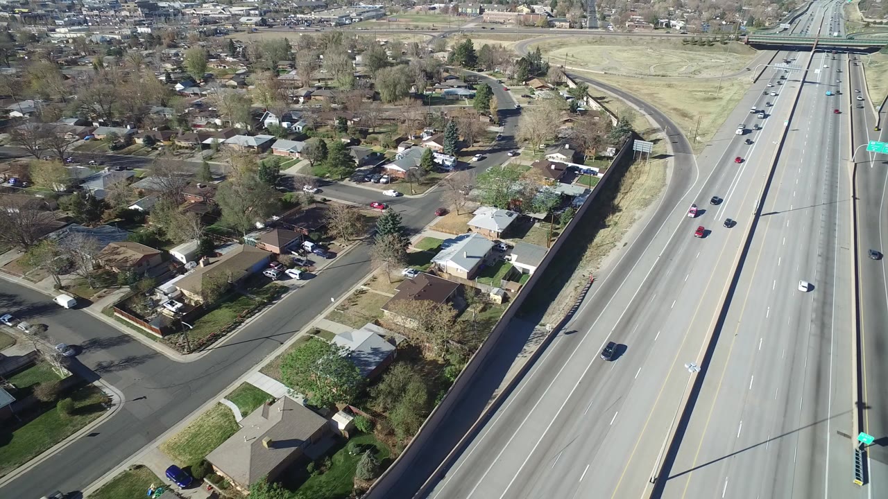 Aerial view of homes beside a multi-lane highway.