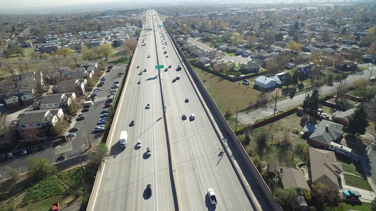 Aerial view of a freeway running through a residential neighborhood.