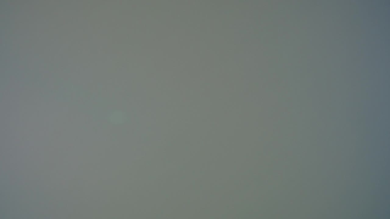 Soft gray blank screen with faint dark edges