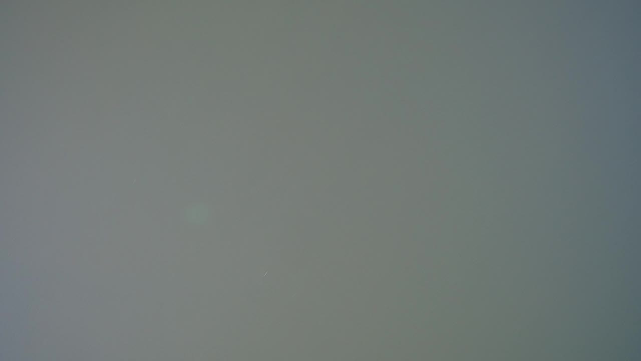 Soft gray-green surface with faint vertical shading