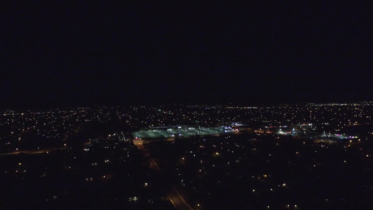 Distant city lights under a dark night sky.