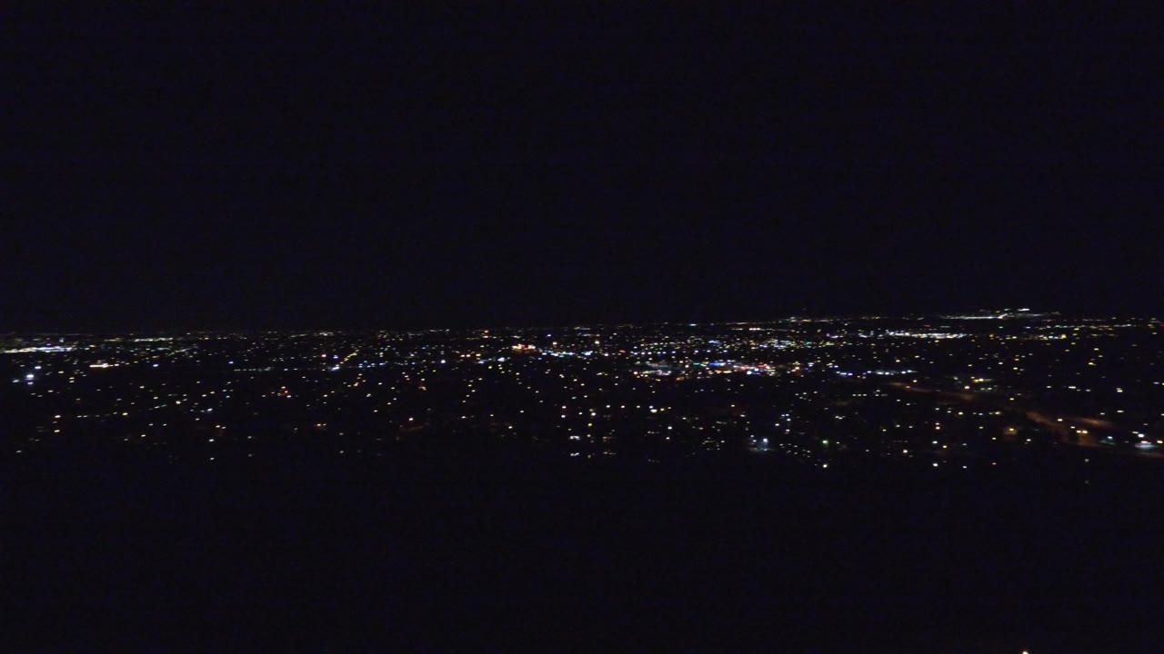 Wide nighttime city lights under a dark sky