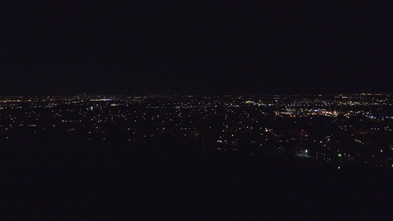 Wide nighttime city lights beneath a dark sky.
